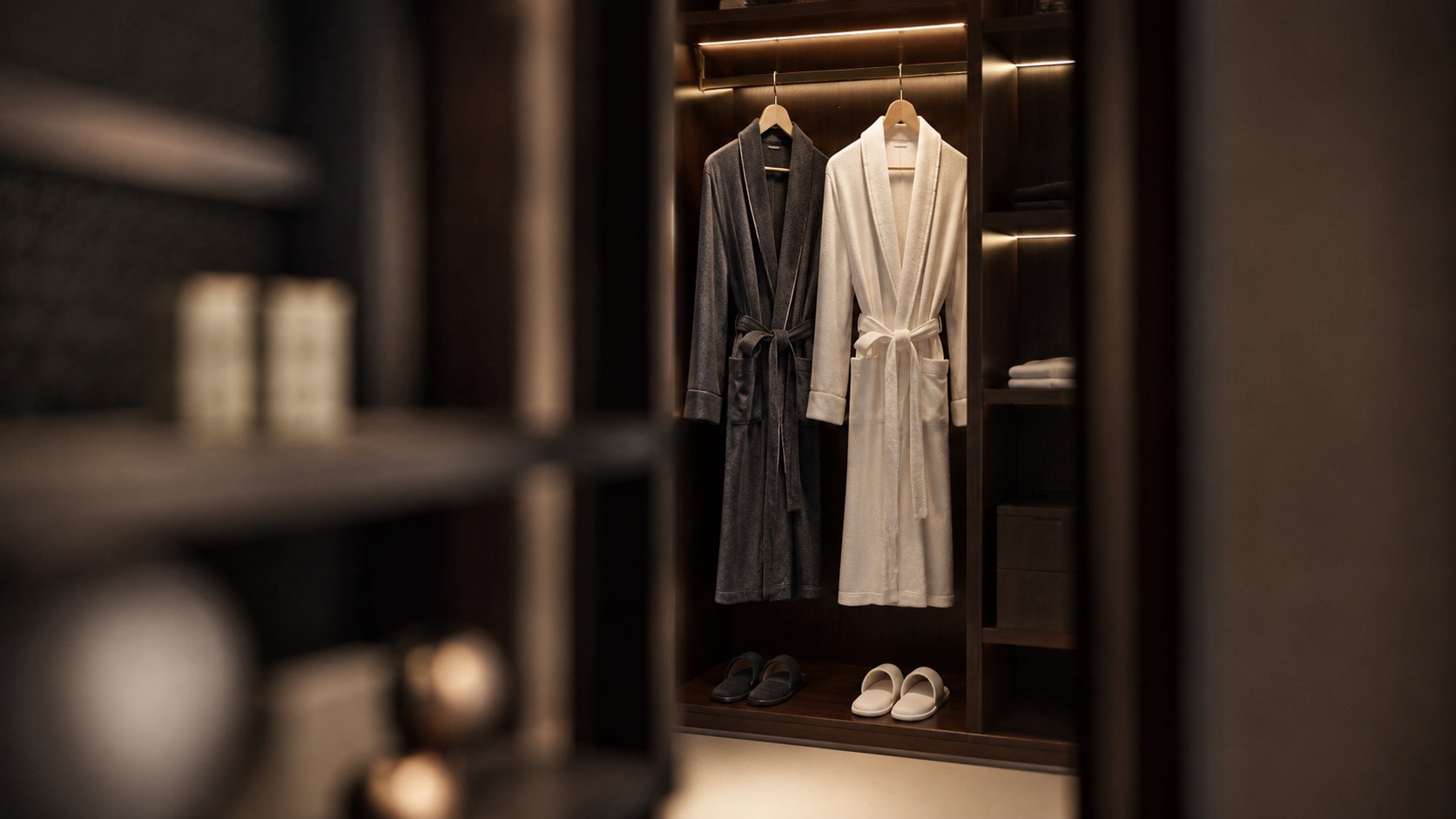Custom hotel robes and slippers hanging in a hospitality suite closet